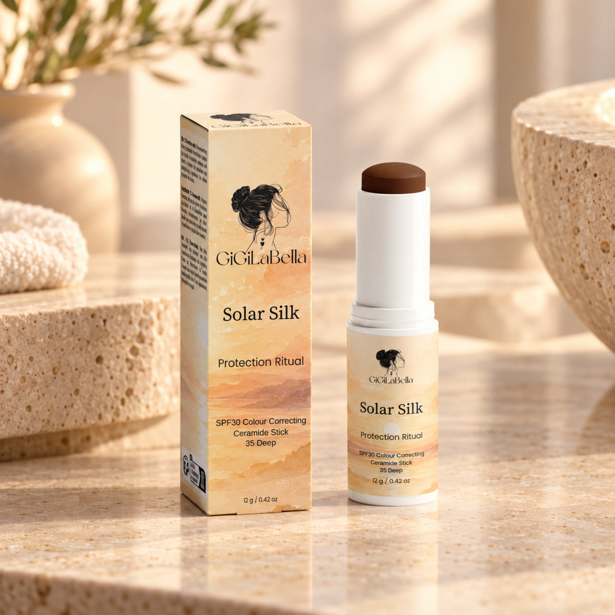 GiGiLaBella Solar Silk SPF30 colour-correcting ceramide stick in shade 35 Deep with carton on a warm limestone vanity